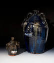D2010-CMD-037. Burlon Craig face jugs, 2010.900.1 (small) and 2010.900.2 (large).